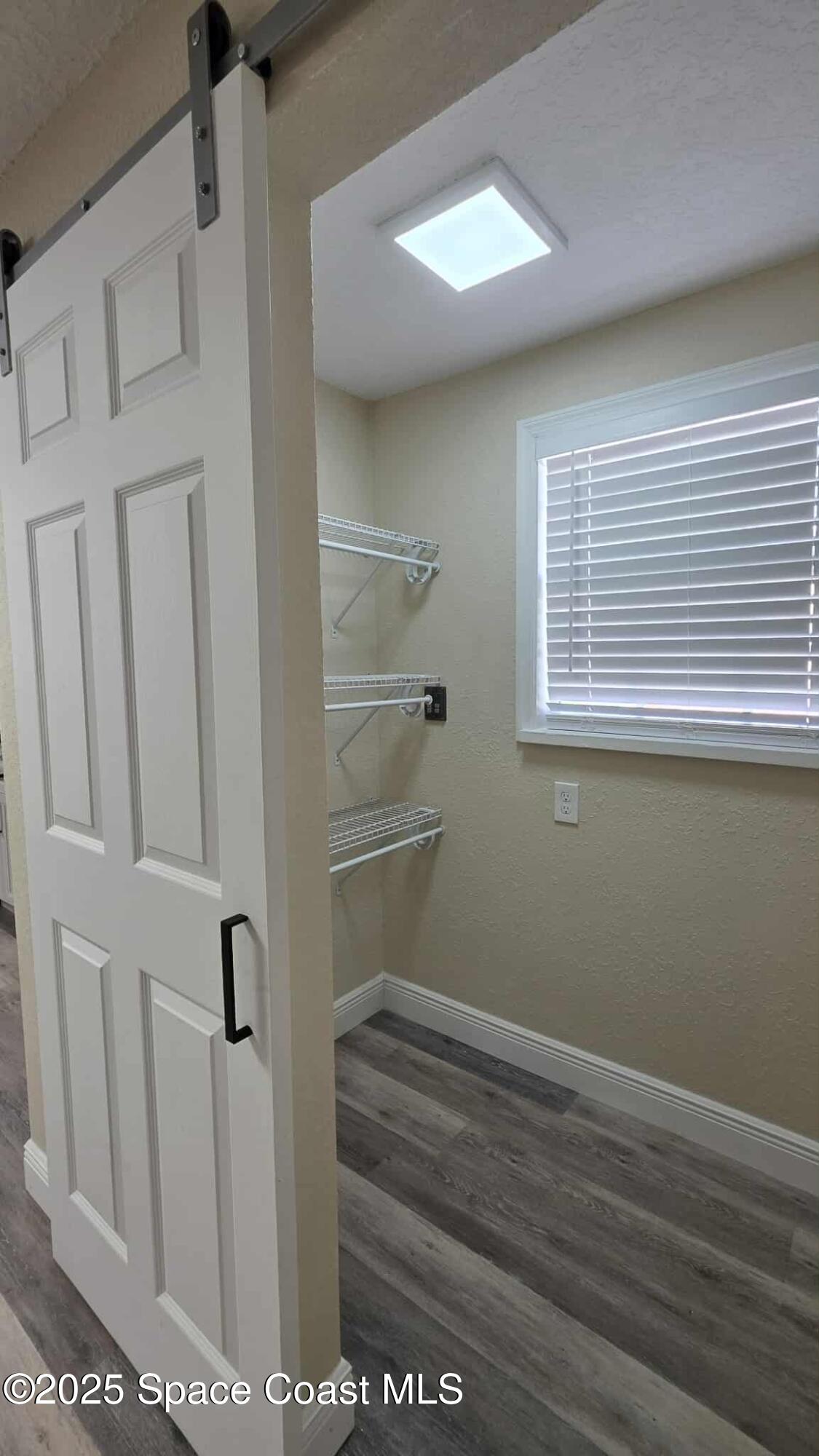 410 4th Street Merritt Island, FL 32953 - Photo 9 of 37 a view of a room with rack on the wall and a window