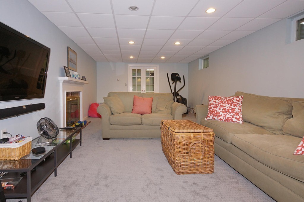 8 Tamarack Road Weston, MA 02493 - Photo 16 of 23 a living room with furniture and a flat screen tv