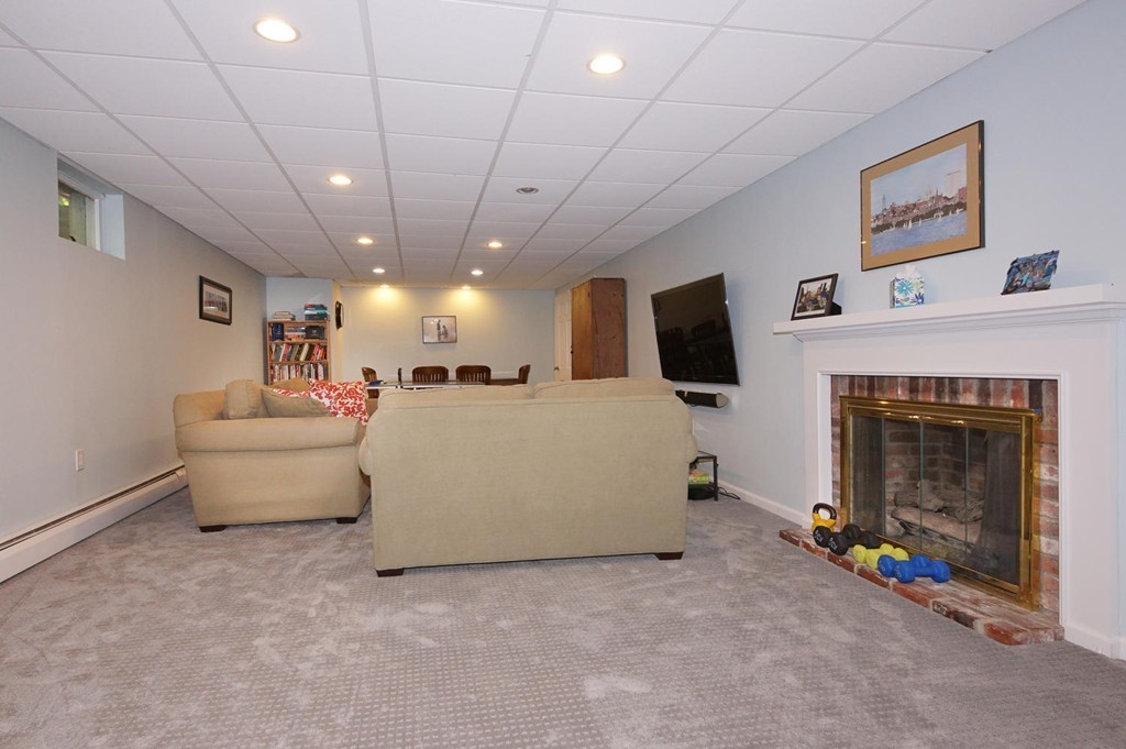 8 Tamarack Road Weston, MA 02493 - Photo 17 of 23 a living room with furniture and a fireplace