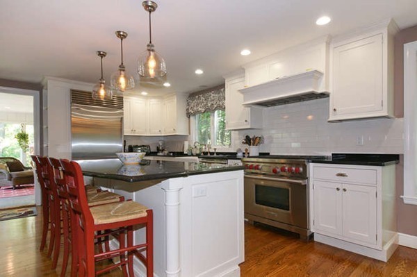 8 Tamarack Road Weston, MA 02493 - Photo 6 of 23 a kitchen with stainless steel appliances granite countertop a stove a sink a refrigerator a dining table and chairs with wooden floor