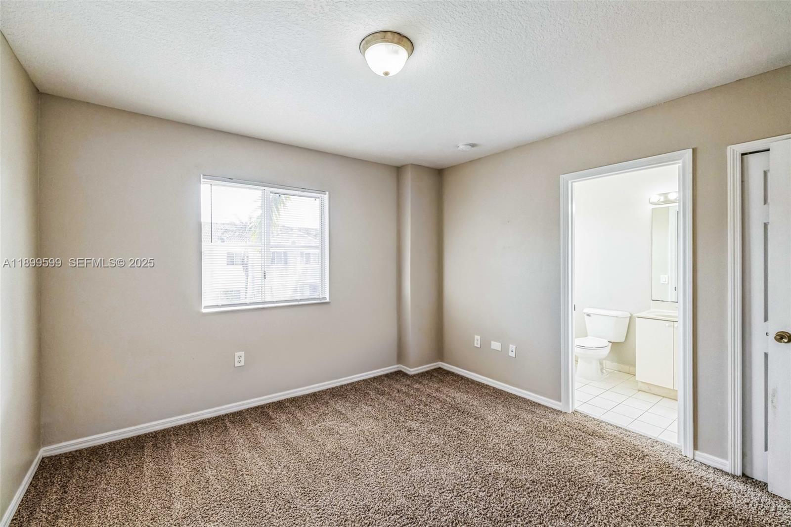 1655 Southeast 30th Street Homestead, FL 33035 - Photo 14 of 17 an empty room with windows and closet