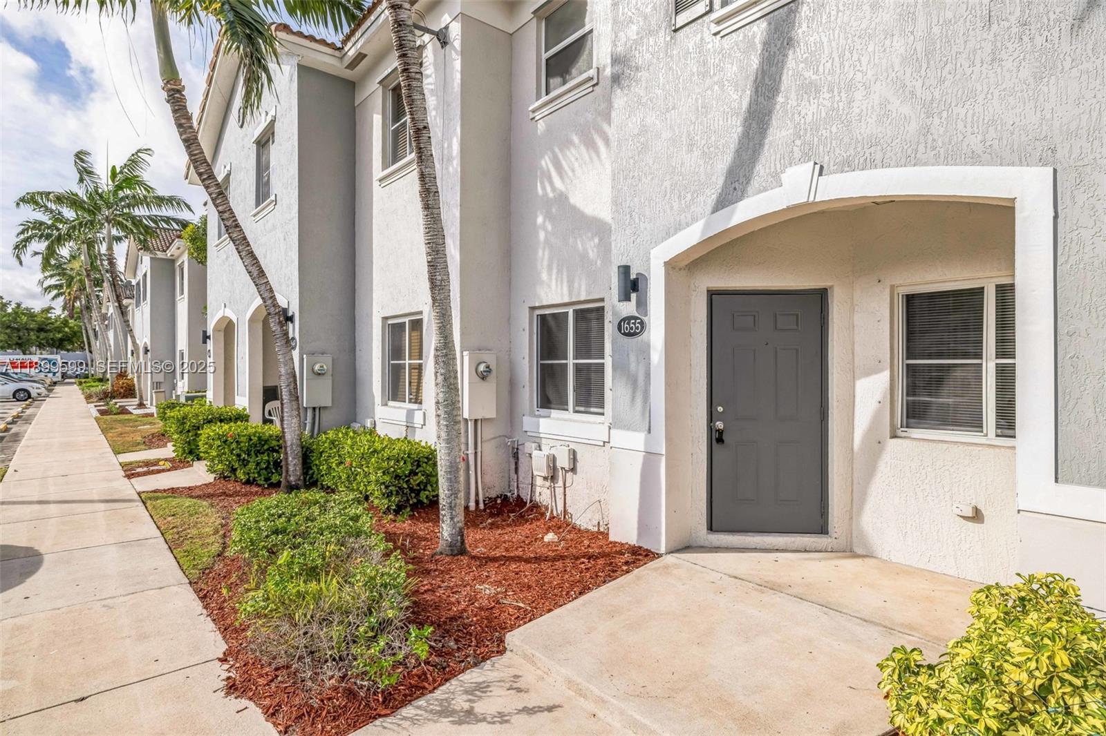 1655 Southeast 30th Street Homestead, FL 33035 - Photo 2 of 17 a front view of a house with a yard