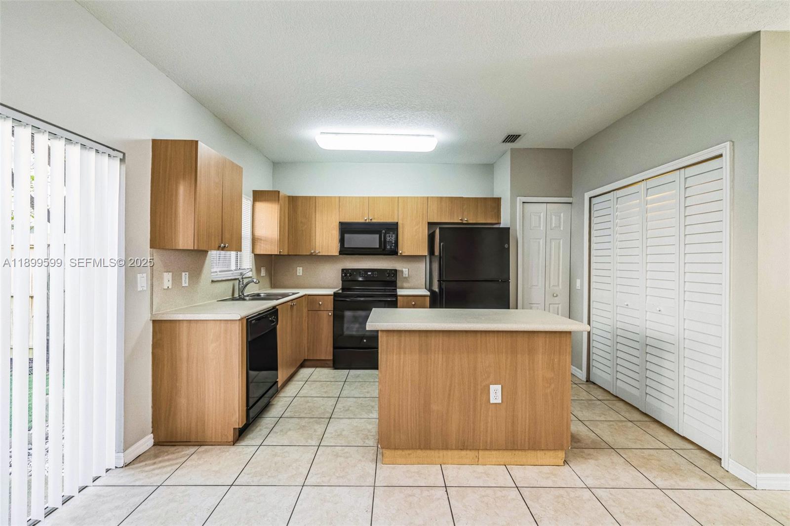 1655 Southeast 30th Street Homestead, FL 33035 - Photo 4 of 17 a large kitchen with stainless steel appliances a refrigerator and a stove top oven
