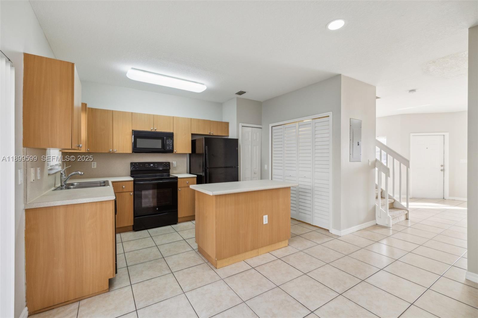 1655 Southeast 30th Street Homestead, FL 33035 - Photo 6 of 17 a kitchen with stainless steel appliances a refrigerator a stove top oven a sink and dishwasher