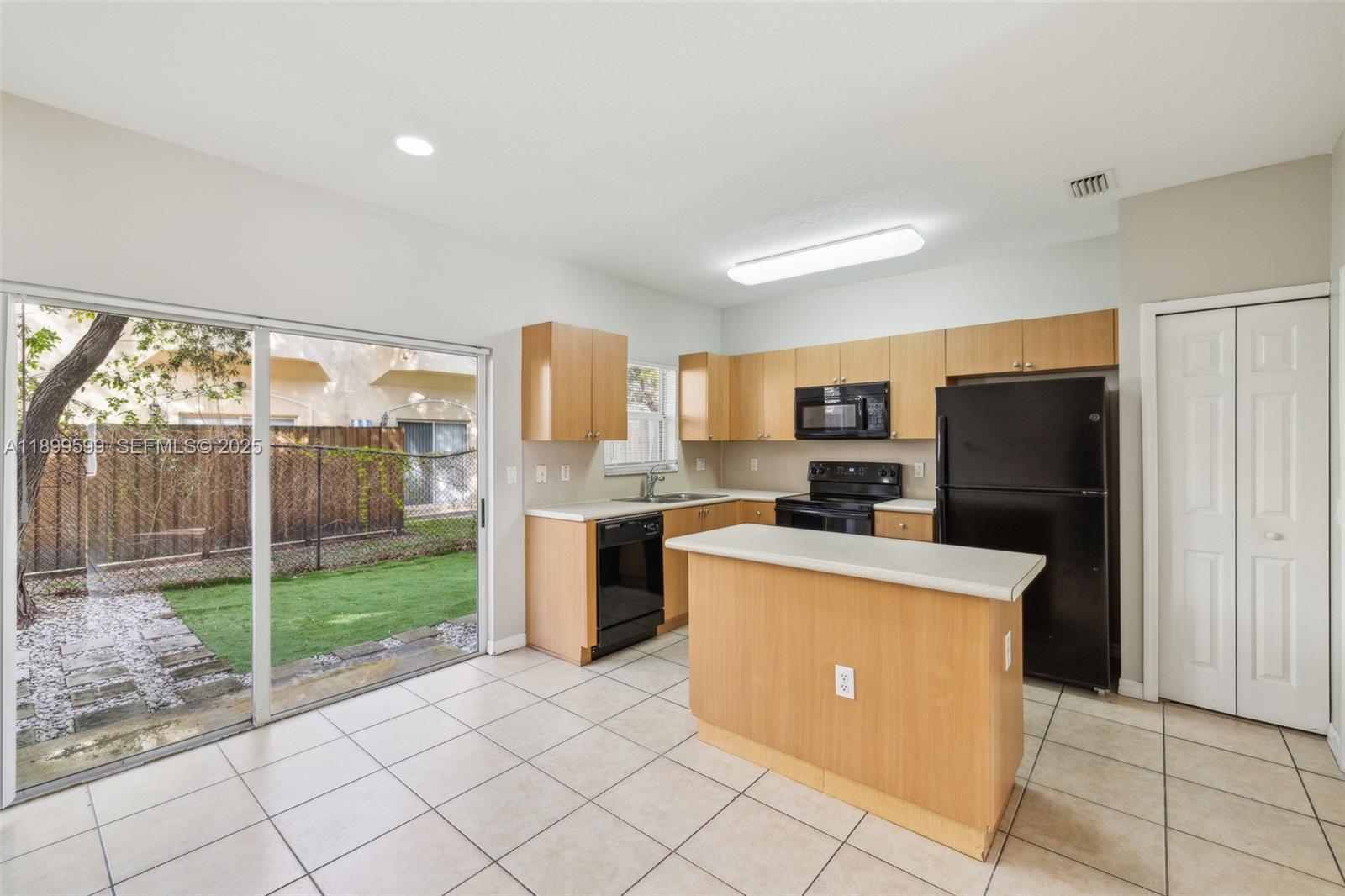 1655 Southeast 30th Street Homestead, FL 33035 - Photo 7 of 17 a kitchen with stainless steel appliances a refrigerator and a stove top oven