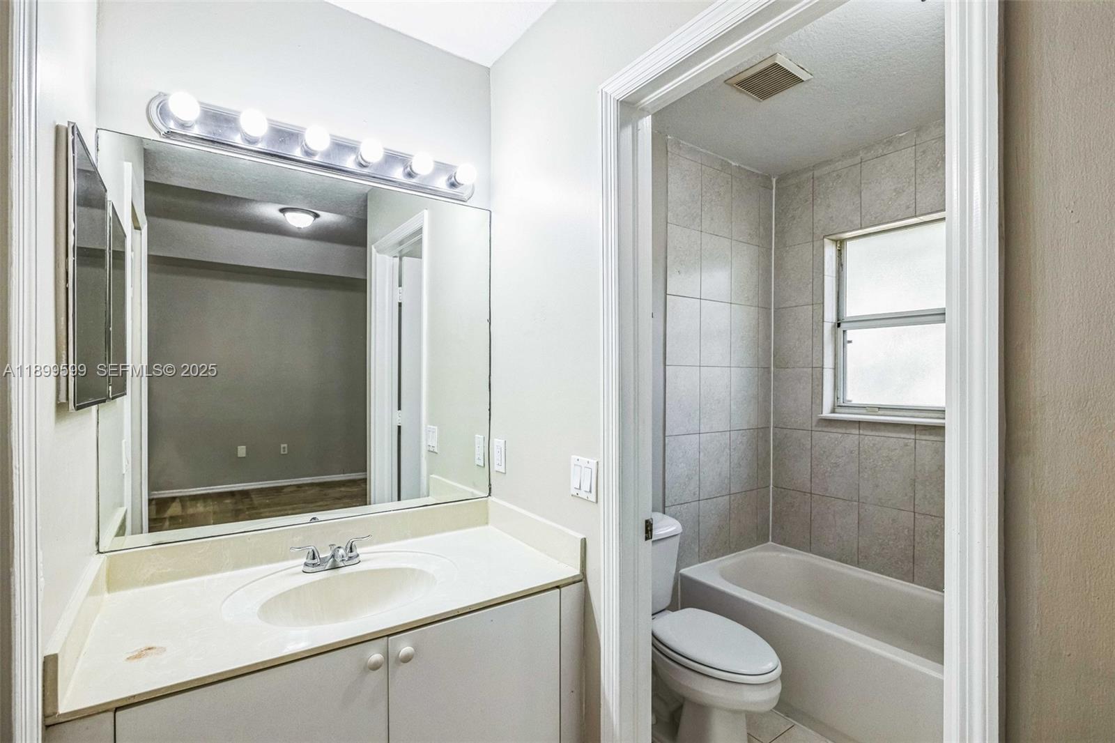1655 Southeast 30th Street Homestead, FL 33035 - Photo 9 of 17 a bathroom with a sink a toilet and shower