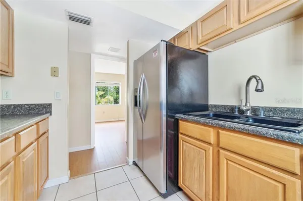 a kitchen with stainless steel appliances granite countertop a refrigerator and a sink