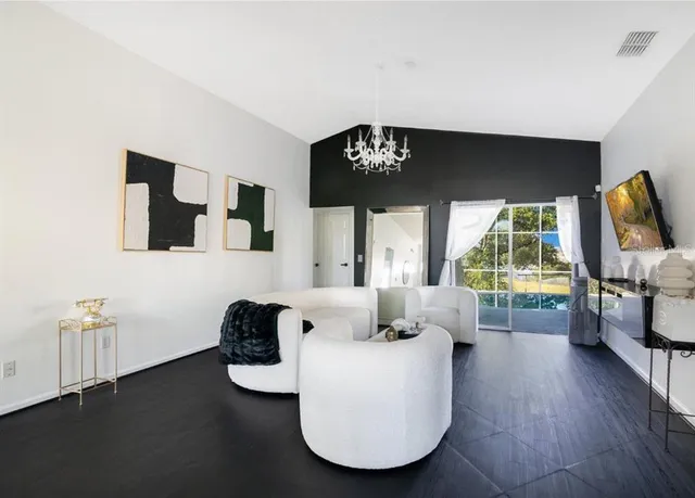 a living room with furniture and a flat screen tv