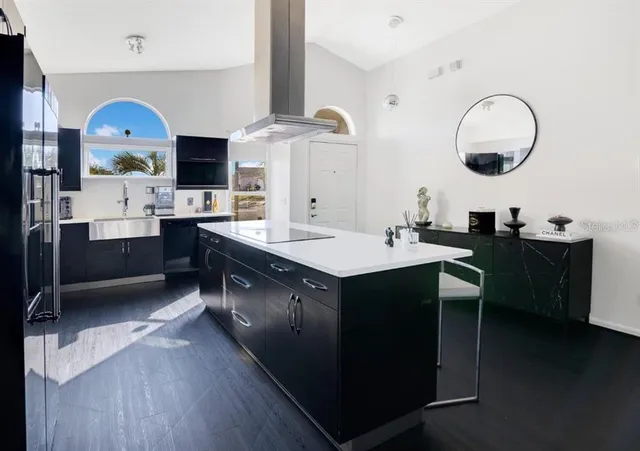 a kitchen with a sink cabinets and wooden floor