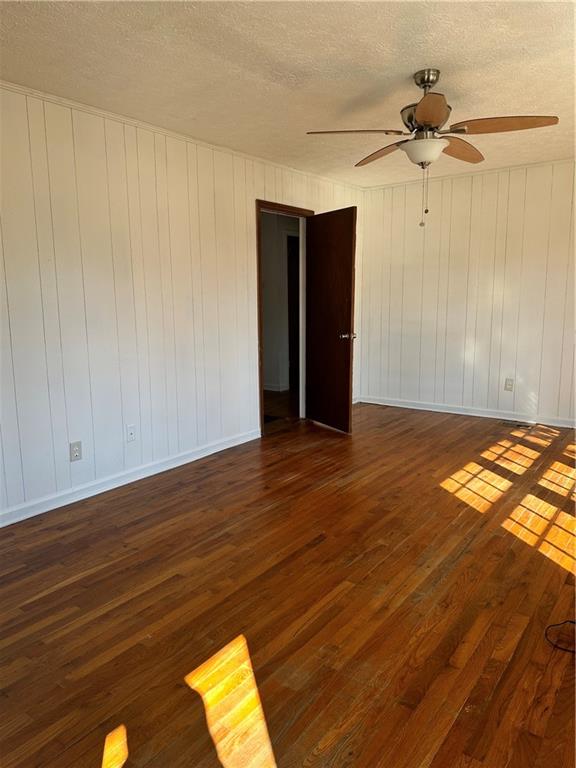 108 Rips Road Calhoun, GA 30701 - Photo 4 of 14 a view of an empty room with wooden floor and a ceiling fan