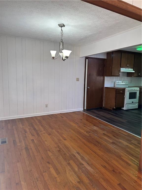 108 Rips Road Calhoun, GA 30701 - Photo 5 of 14 a view of a kitchen with stainless steel appliances wooden floor and a chandelier