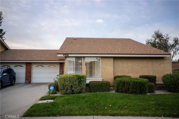a aerial view of a house with a yard and garage