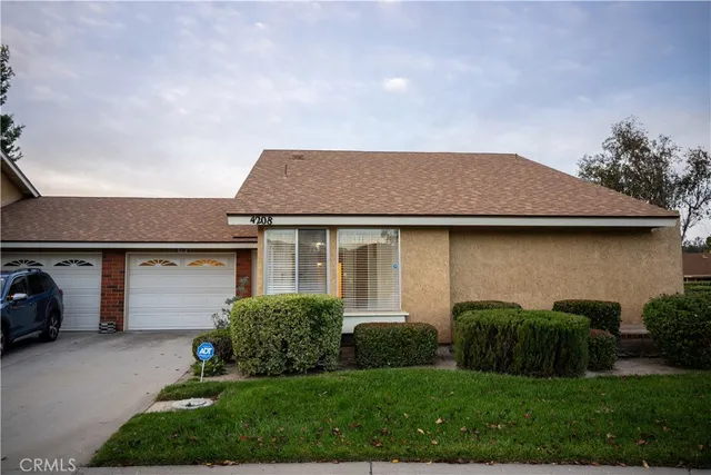 a aerial view of a house with a yard and garage