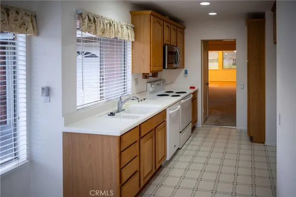 a kitchen with stainless steel appliances granite countertop a sink and a stove