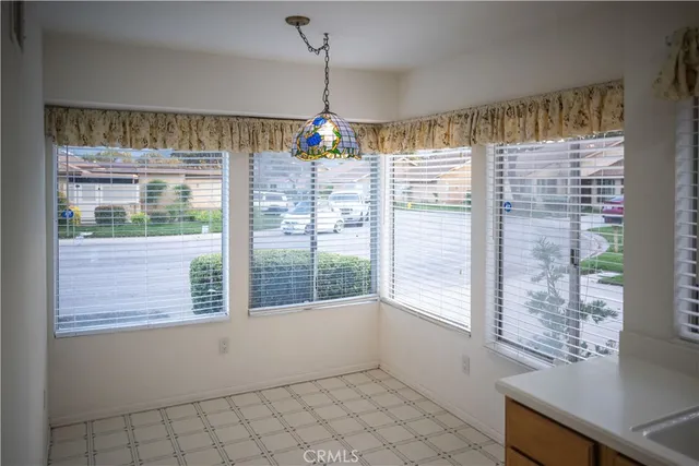 a view of empty room with wooden floor and windows