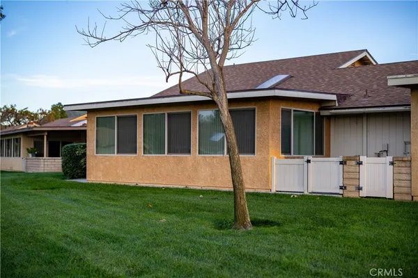a view of house with a yard