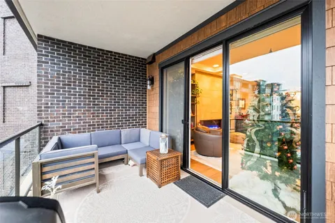 a living room with furniture and a floor to ceiling window