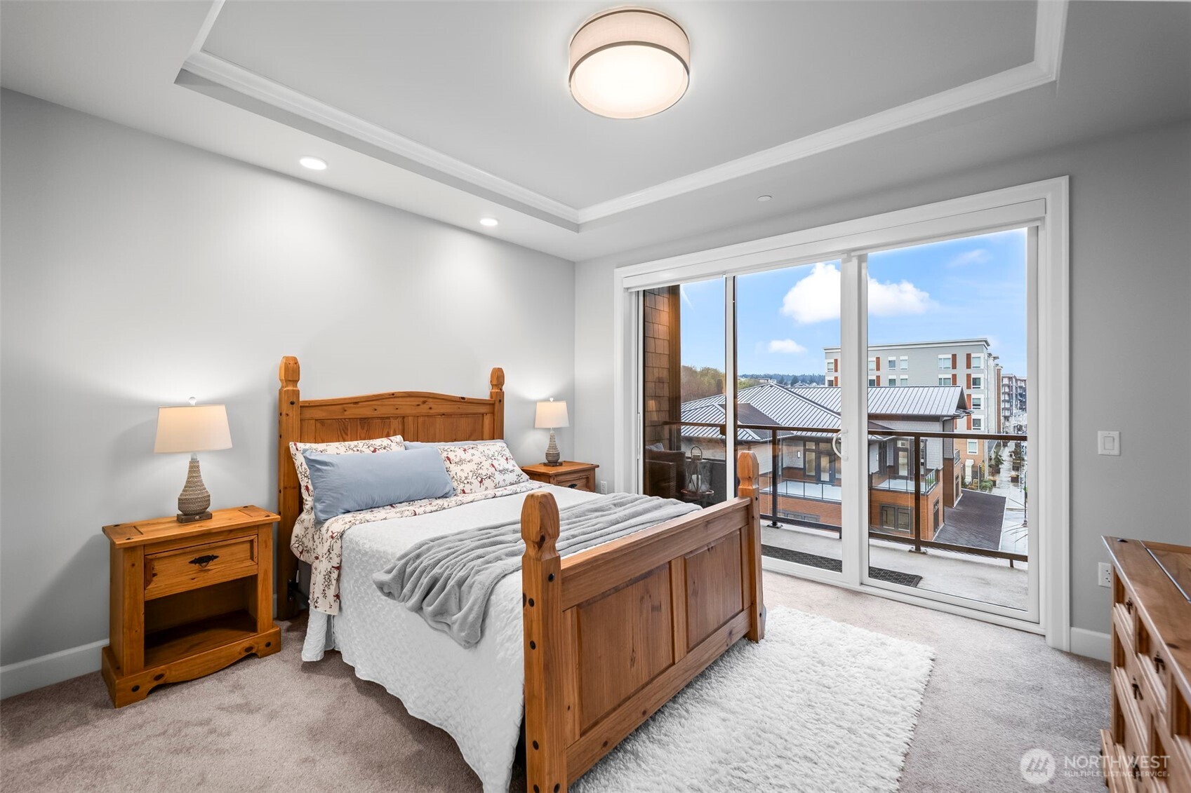 4907 Main Street, Unit 625 Tacoma, WA 98407 - Photo 14 of 40 a bedroom with a large bed and a chandelier