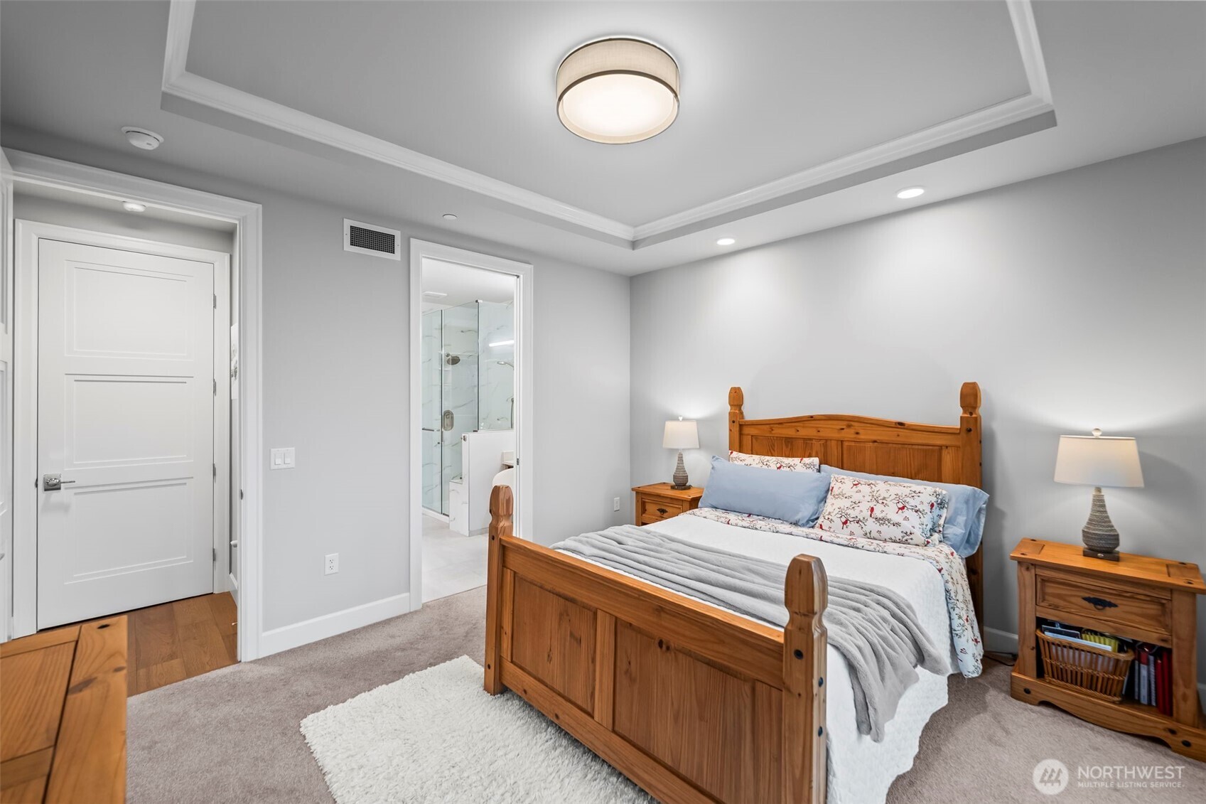4907 Main Street, Unit 625 Tacoma, WA 98407 - Photo 16 of 40 a bedroom with a bed and a dresser with wooden floor
