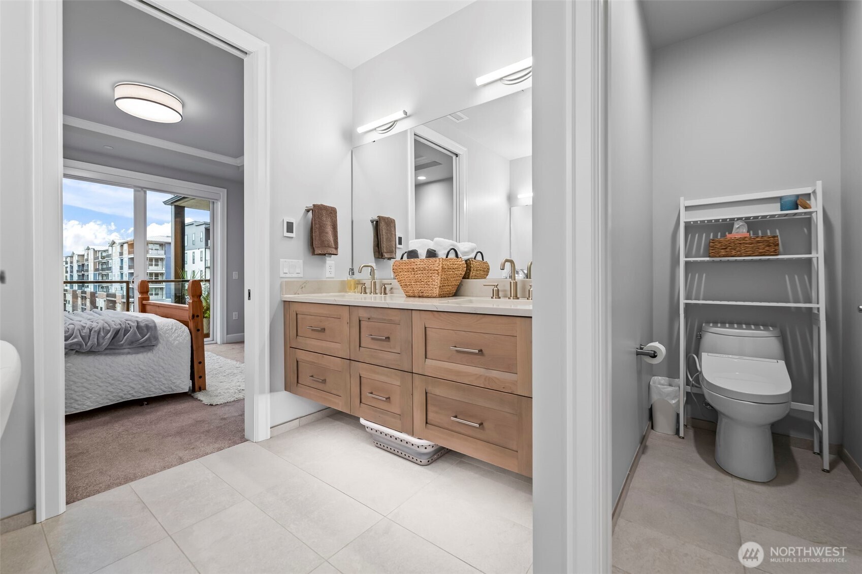 4907 Main Street, Unit 625 Tacoma, WA 98407 - Photo 17 of 40 a spacious bathroom with a toilet sink and mirror