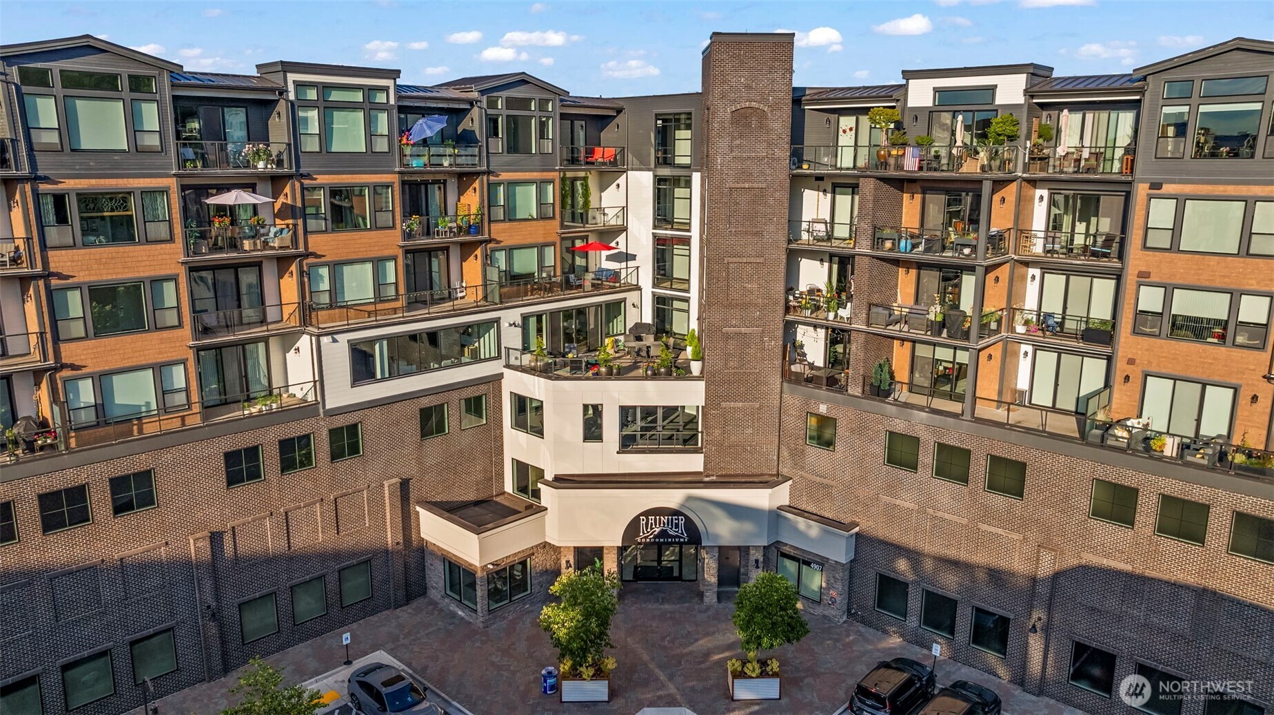 4907 Main Street, Unit 625 Tacoma, WA 98407 - Photo 2 of 40 a front view of a residential apartment building with a yard