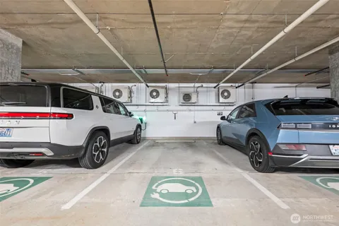 a view of parking garage with cars parked