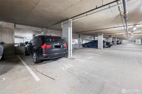 a view of parking garage with cars