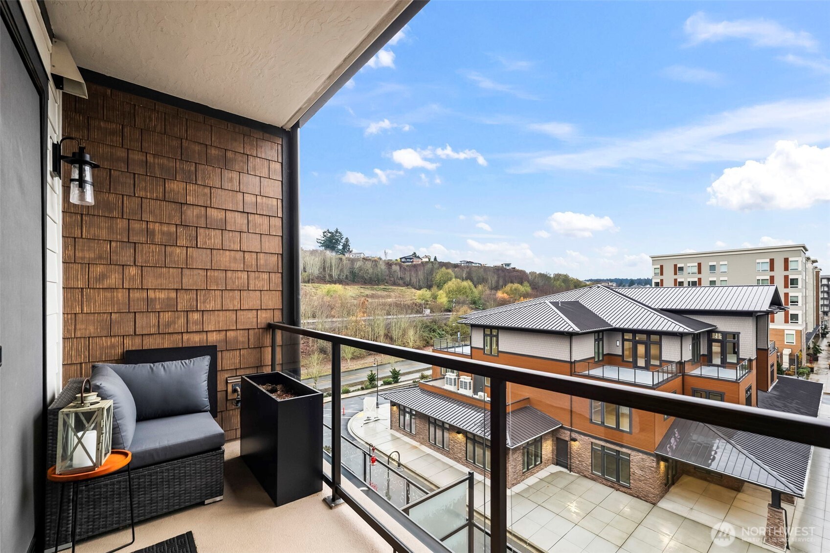 4907 Main Street, Unit 625 Tacoma, WA 98407 - Photo 4 of 6 a view of a balcony with furniture and a potted plant
