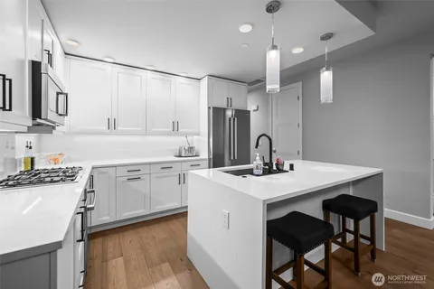 a kitchen with stainless steel appliances granite countertop a sink stove and refrigerator