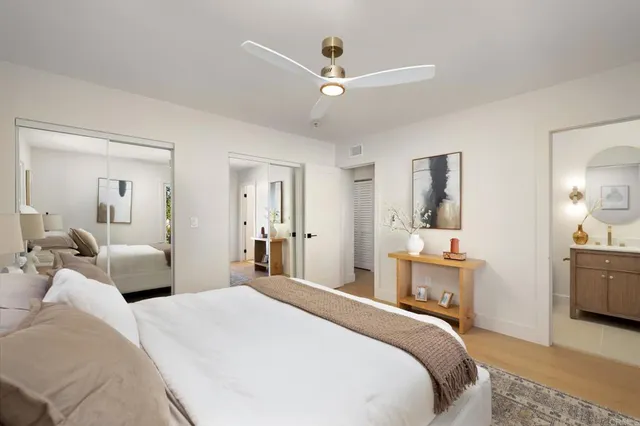 a bedroom with a bed and ceiling fan