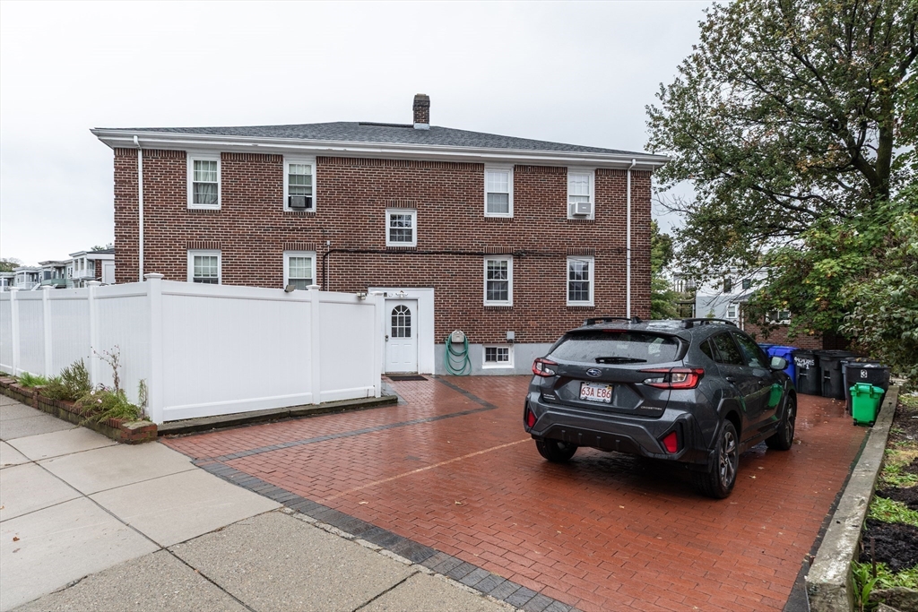 440 Adams Street, Unit 1 Boston, MA 02122 - Photo 17 of 18 a car parked in front of a house
