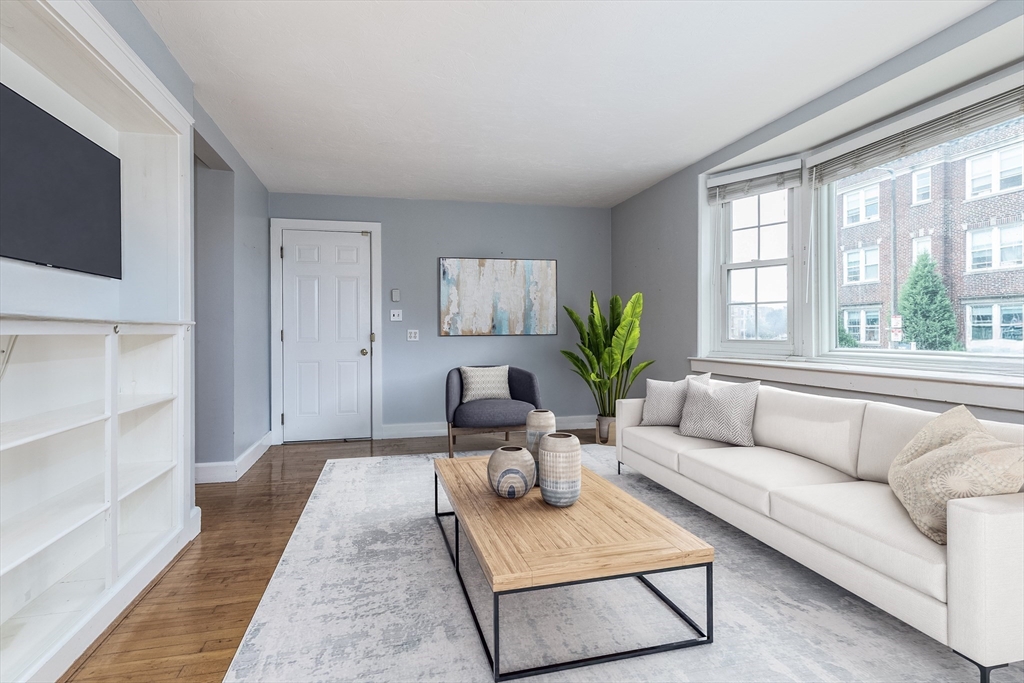 440 Adams Street, Unit 1 Boston, MA 02122 - Photo 2 of 18 a living room with furniture and a large window