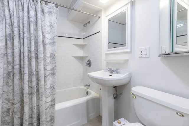 a bathroom with a sink toilet and bathtub