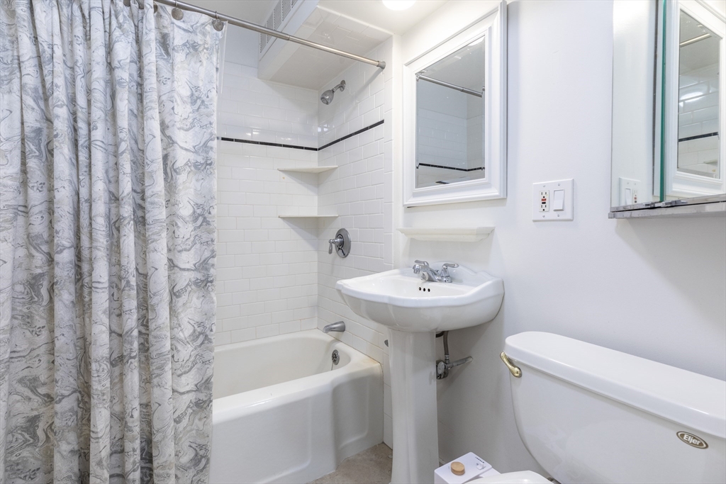 440 Adams Street, Unit 1 Boston, MA 02122 - Photo 9 of 18 a bathroom with a sink toilet and bathtub