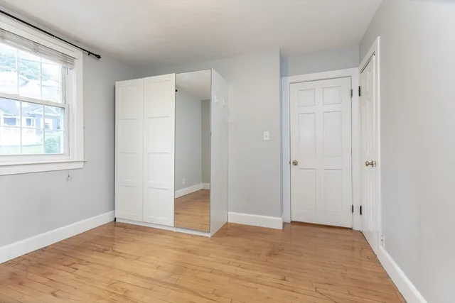 an empty room with windows and closet