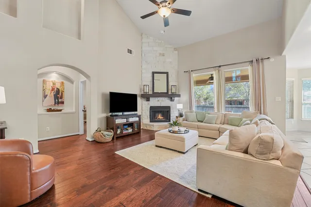 a living room with furniture flat screen tv and a fireplace