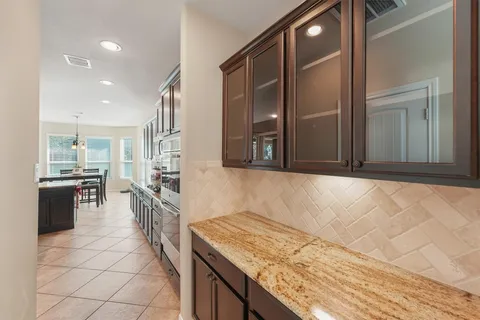 a kitchen with stainless steel appliances granite countertop a sink and a stove