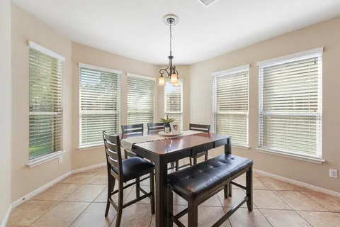 a dining room with furniture and window