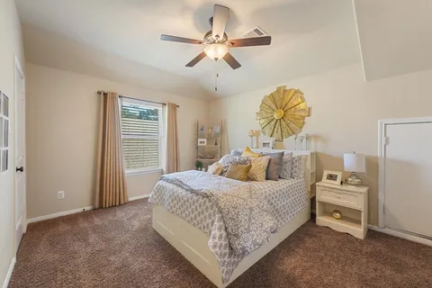 a bedroom with a bed and dresser with mirror