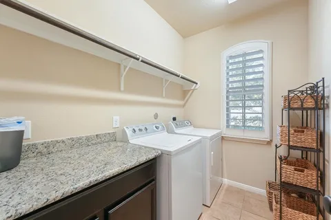a bathroom with a granite countertop sink and a window