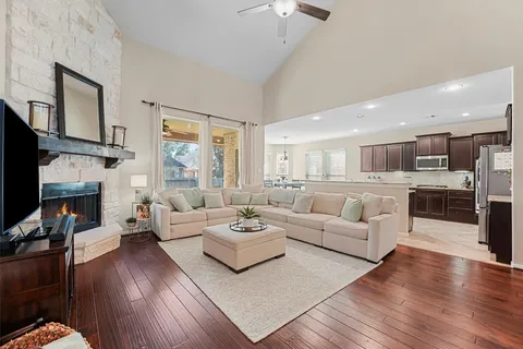 a living room with fireplace furniture and a wooden floor