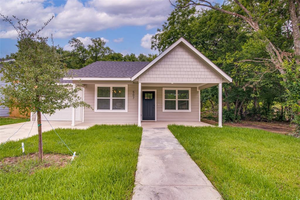507 Campbell Street Terrell, TX 75160 - Photo 13 of 13 a front view of a house with a yard and garage