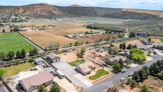 7776 Wagon Road East St. George, UT 84770 - Photo 72 of 76 Aerial view of property's location featuring rural landscape, nearby suburban area, and a mountainous background