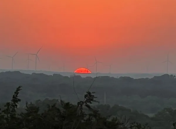 a view of sunset and mountains