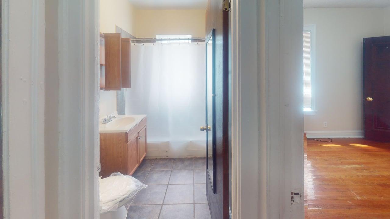 823 West 83rd Street, Unit 1N Chicago, IL 60620 - Photo 5 of 8 a bathroom with a toilet sink and tub