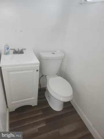 a white toilet sitting next to a bathroom sink