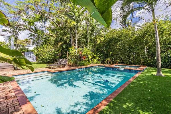 a view of yard with swimming pool and patio