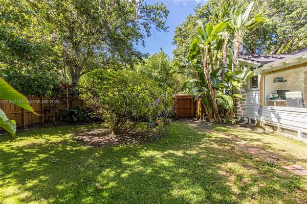 a view of a house with backyard and sitting area