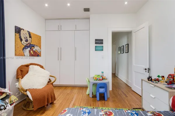 a bed sitting in a bedroom next to a window