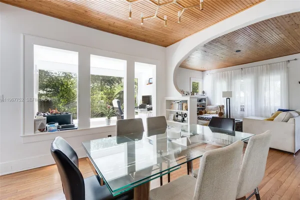 a kitchen with stainless steel appliances a stove a sink cabinets and a wooden floor
